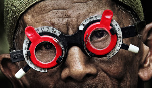 A perpetrator has his eyes checked by a victim's son in "The Look of Silence."